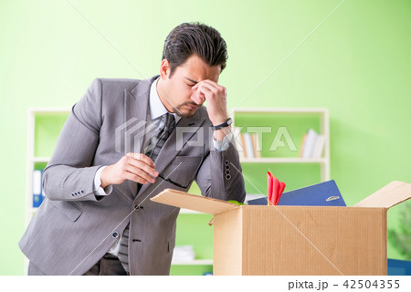 Male employee collecting his stuff after redundancy Male employee collecting his stuff after redundancy 42504355