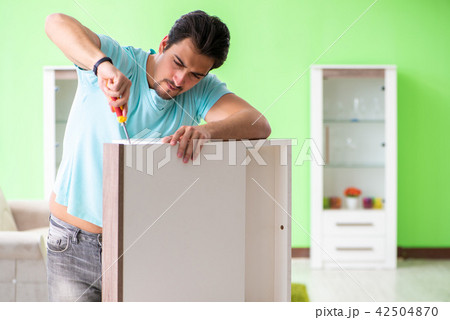 Man repairing furniture at home Man repairing furniture at home 42504870