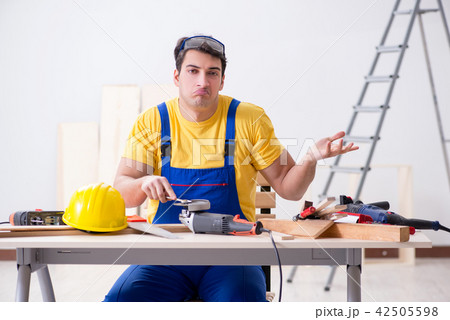Floor repairman disappointed with his work Floor repairman disappointed with his work 42505598