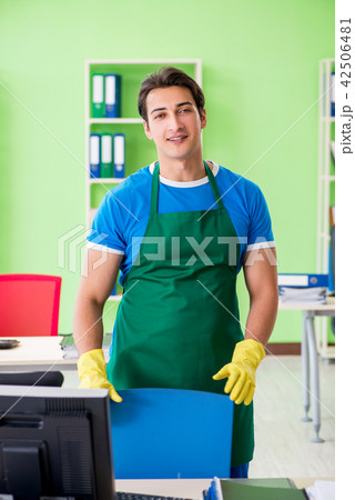 Male handsome professional cleaner working in the office 42506481