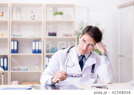 Young doctor sitting in the office Young doctor sitting in the office 42508038