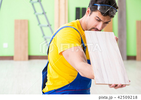 Professional contractor laying flooring at home Professional contractor laying flooring at home 42509218
