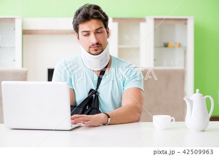 Young student man with neck and hand injury at home Young student man with neck and hand injury at home 42509963