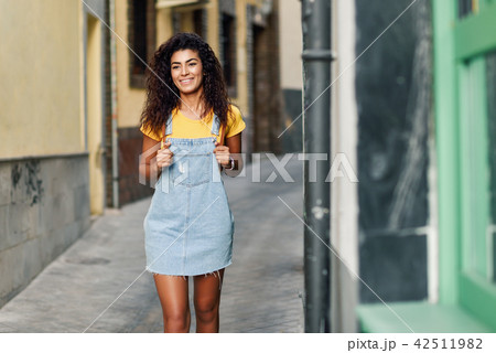 Young North African woman with black curly hairstyle outdoors. Young North African woman with black curly hairstyle outdoors. 42511982