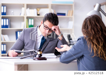 Lawyer discussing legal case with client Lawyer discussing legal case with client 42512518
