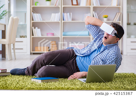 Freelance student with virtual reality glasses at home Freelance student with virtual reality glasses at home 42515367