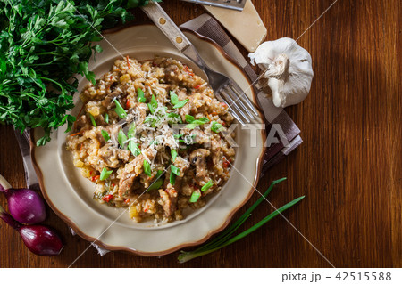 Risotto with mushrooms, pork and parmesan 42515588