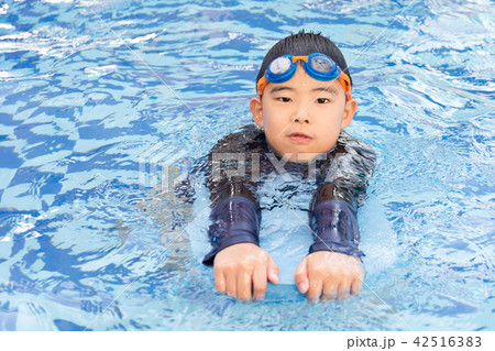 young boy swimming in pool. young boy swimming in pool. 42516383