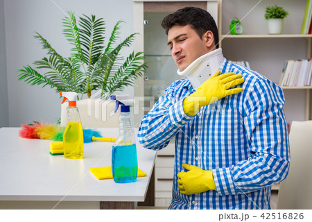 Man with neck unjury cleaning house in housekeeping concept 42516826