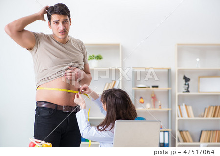 Doctor dietician giving advices to fat overweight patient Doctor dietician giving advices to fat overweight patient 42517064