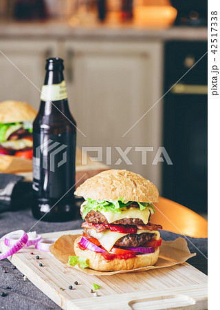 Cheeseburger with  Bottle of Beer and Some Ingredients. 42517338