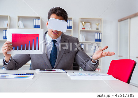 Businessman with virtual reality glasses in the office 42517385