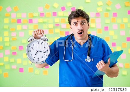 Young doctor with many reminders and urgent work Young doctor with many reminders and urgent work 42517386