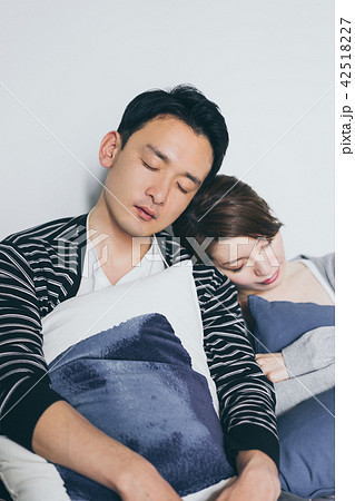 寄り添って眠るカップルの写真素材