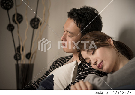 寄り添って眠るカップルの写真素材