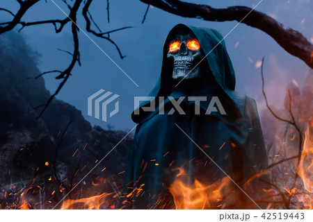 Death in black hoodie with burning eyes in forest Death in black hoodie with burning eyes in forest 42519443