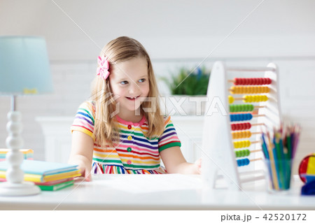 Child with abacus doing homework after school. 42520172