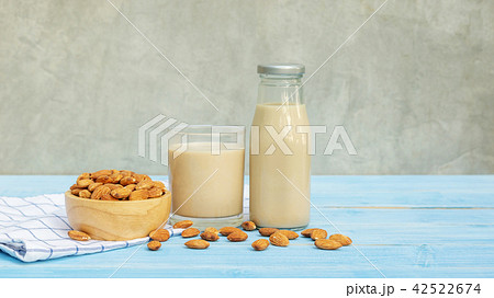 Almond milk on a blue wooden table. 42522674