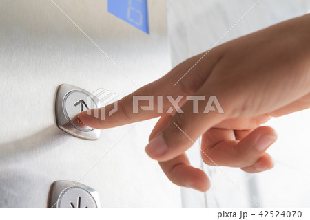 Close up woman hand press a up button of elevator Close up woman hand press a up button of elevator 42524070