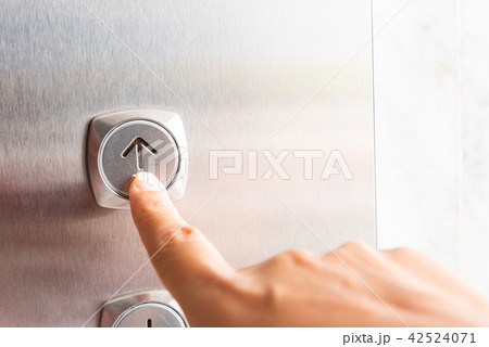 Close up woman hand press a up button of elevator Close up woman hand press a up button of elevator 42524071