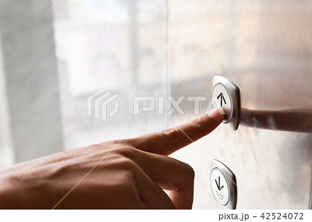 Close up woman hand press a up button of elevator 42524072