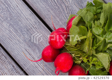 Fresh radish on wooden table close up. 42529370