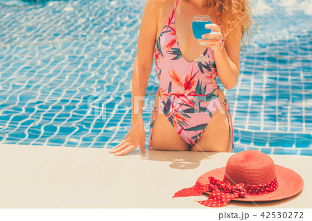Happy young woman in swimsuit at swimming pool. Happy young woman in swimsuit at swimming pool. 42530272