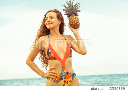 Happy woman wearing swimsuit on beach in summer Happy woman wearing swimsuit on beach in summer 42530369