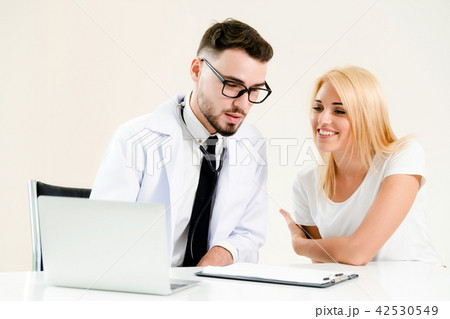 Male Doctor and Female Patient in Hospital Office 42530549