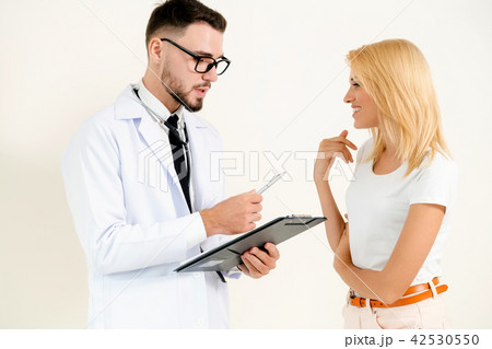 Male Doctor and Female Patient in Hospital Office Male Doctor and Female Patient in Hospital Office 42530550
