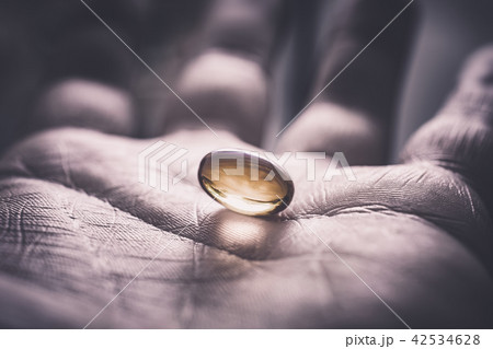 Gelatine Pill In A Dark And Used Looking Hand 42534628