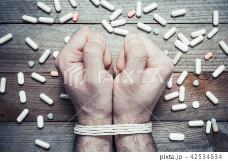 Pill Abuse Concept With Tied Hands And Many Pills 42534634