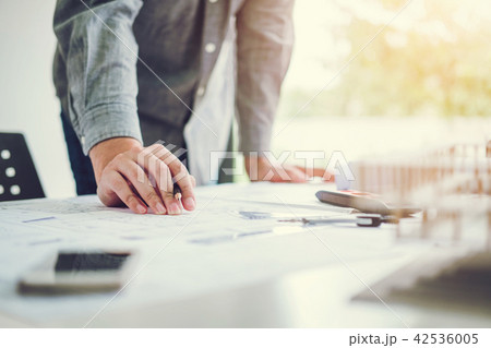 Architect or engineer working in office blueprint 42536005