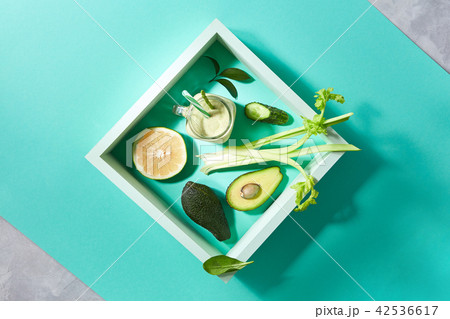 Natural ingredients for healthy smoothie from avocado with cucumber, celery, shpinach, lemon in jar 42536617