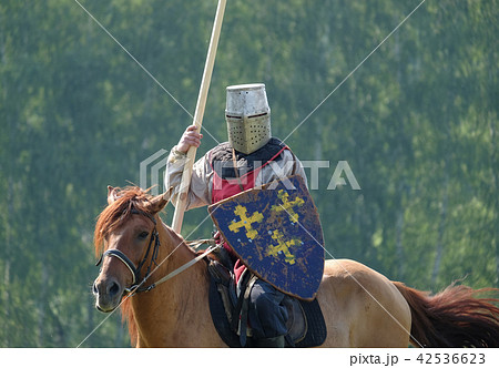 medieval knight with a spear riding a horse 42536623