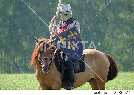 medieval knight with a spear riding a horse 42536624
