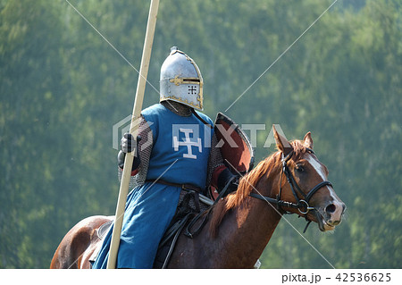 medieval knight with a spear riding a horse 42536625