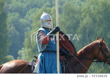 medieval knight with a spear riding a horse 42536626