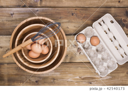 identical wooden plates of different sizes, corolla for cooking and eggs, on a wooden background. identical wooden plates of different sizes, corolla for cooking and eggs, on a wooden background. 42540173