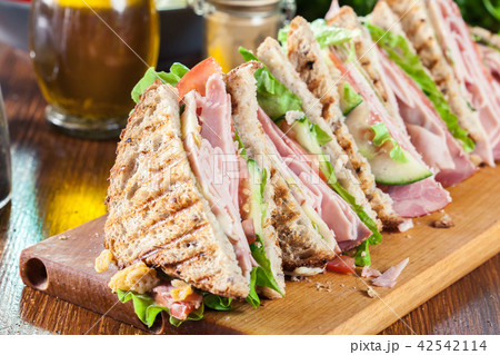 Sandwiches with ham, cheese, tomatoes and cucumber Sandwiches with ham, cheese, tomatoes and cucumber 42542114