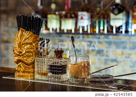 a glass tiki on the bar 42543565
