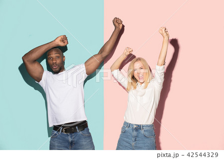 We won. Winning success happy afro man and woman celebrating being a winner. Dynamic image of We won. Winning success happy afro man and woman celebrating being a winner. Dynamic image of 42544329