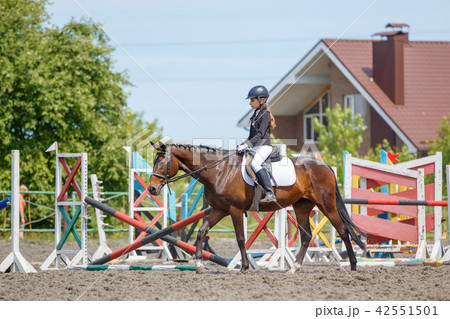 Girl riding horse for warm up before perfomance Girl riding horse for warm up before perfomance 42551501