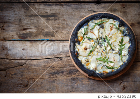 Top view black pizza on wooden background Top view black pizza on wooden background 42552390