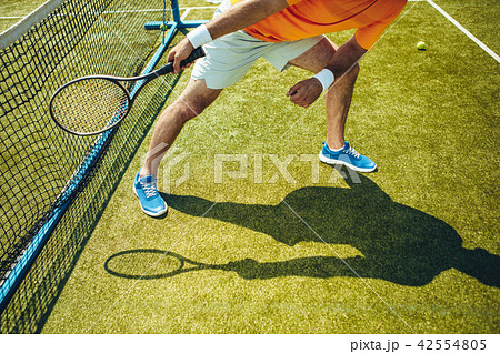 Man arm exercising in tennis game Man arm exercising in tennis game 42554805