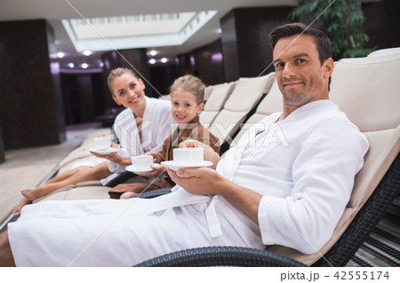 Happy family drinking tea after swimming 42555174