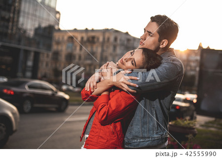 Affectionate man and woman embracing in tenderness outdoors 42555990
