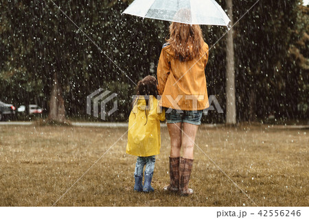 Mother and daughter enjoying rain Mother and daughter enjoying rain 42556246