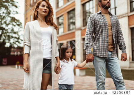 Caring family walking on street 42556394