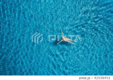 Aerial view of swimming woman in the sea Aerial view of swimming woman in the sea 42556453